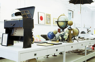 Photograph of a large central table and retail display cases for Partners & Spade's original downtown office & storefront. Design: Partners & Spade, Rogers Marvel Architects